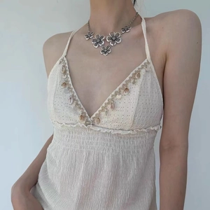 Bohemian style aged flower pendant metal necklace worn by model on white background