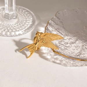 Golden peace dove ring with detailed feather texture in polished stainless steel
