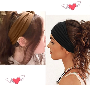 Detail view of wide knotted headbands in brown and black fabric for yoga and sports