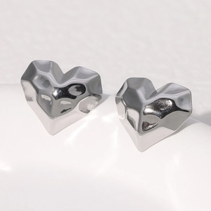 Sleek silver heart stud earrings in stainless steel with a faceted geometric texture