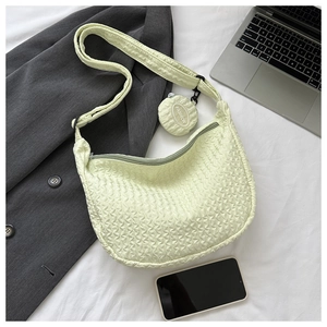 Detail of light yellow crescent shoulder bag with pleated texture and coin purse