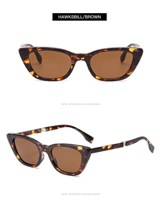 Detail view of foldable tortoiseshell cat eye sunglasses with brown lenses and metal hinges