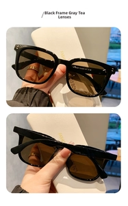 Detalle de gafas de sol cuadradas vintage con montura negra y lentes polarizadas marrones