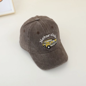 Detailed texture of brown corduroy kids cap with vintage car and Motor Club embroidery
