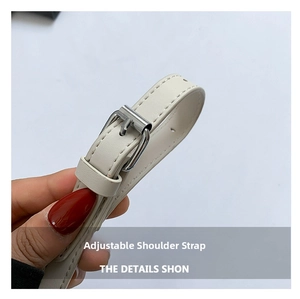 Detail of adjustable off-white faux leather shoulder strap with silver metal buckle