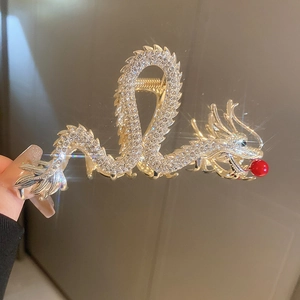 Macro view of crystal-encrusted dragon hair claw clip with a red bead detail