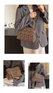 Detail shot of leopard print shoulder bag featuring premium gold metal chain straps
