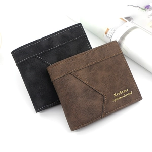 Detail of matte men's wallets showing gold-stamped lettering and geometric stitching