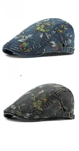 Detail of vintage floral denim flat caps featuring adjustable metal buckles in dark blue and black