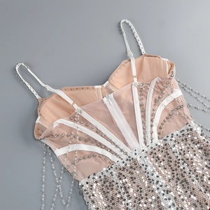 Detailed close-up of silver sequin top featuring crystal bead chains and mesh fabric