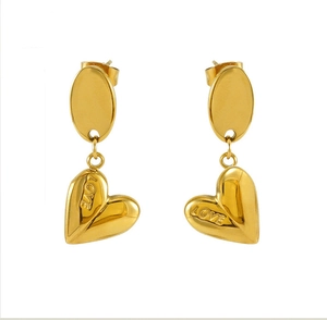 Close-up of gold-plated heart earrings featuring LOVE engraving on polished stainless steel