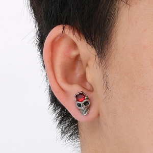Gothic punk skull stud earring in silver steel with a sparkling red gemstone inlay