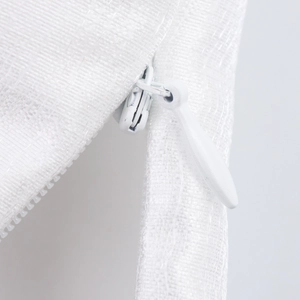 Detailed view of a white invisible zipper on a textured two-piece floral set garment