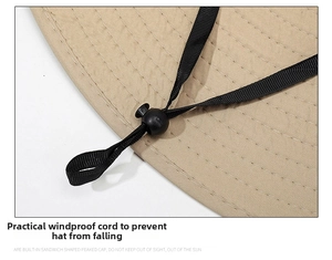 Detail of adjustable windproof rope and toggle on khaki wide brim outdoor sun hat