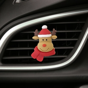 Close-up of a brown silicone reindeer car vent clip with a red Christmas hat and scarf