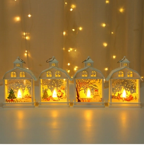 Detailed view of four white LED Christmas lanterns with festive painted holiday scenes