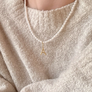 French style pearl necklace with gold letter A pendant and bamboo texture detail