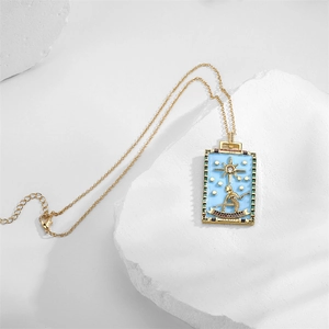 Detail of The Star tarot card pendant in blue enamel with gold plating on white stone