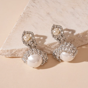 Elegant silver drop earrings featuring large white pearls and sparkling pavé diamonds