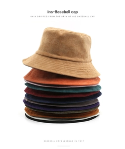 Close-up of stacked corduroy bucket hats in various colors showing soft ribbed texture
