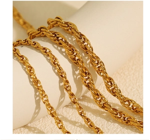 Detail view showing four different thicknesses of gold-plated twisted rope chain necklaces