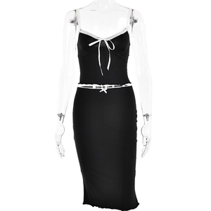 Detail of black two-piece skirt set featuring white lace trim and bow decorations