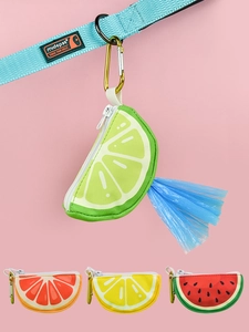 Detail of fruit-shaped pet waste bag dispensers with metal clips on a blue leash