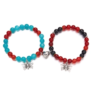 Detail view of spider charm bead bracelets with magnetic heart closure for couples