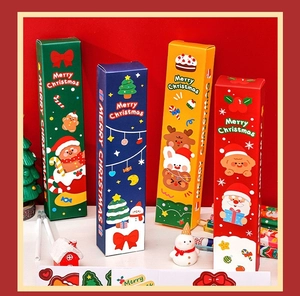 Set of four colorful Christmas themed stationery gift boxes with cute festive characters