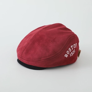Detail of red suede newsboy cap with Boston embroidery and black corduroy brim