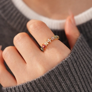 Detailed close-up of 18k gold plated open ring with colorful zircon stones on hand