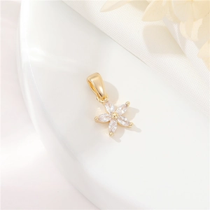 Macro shot of 14k gold-plated five-petal flower pendant with micro-set zircon crystals