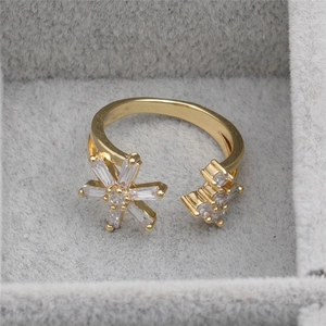 Gold plated open ring with snowflake zircon design displayed in a grey jewelry box