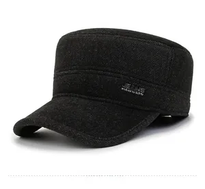 Detail of a black flat top military cap featuring a textured fabric and JEANS metal side tag