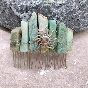 Detail of bohemian crystal hair comb with turquoise raw stones and sun pendant detail