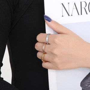 Detail showing checkered texture on gold, silver, and rose gold stainless steel rings