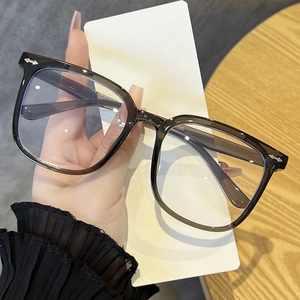 Detail of grey transparent oversized glasses frame with blue light blocking lenses