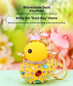 Close-up of yellow duck keychain with colorful crystals and a golden crown