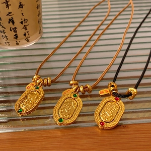 Detail of gold-plated Chinese pendants with relief patterns on premium woven cords