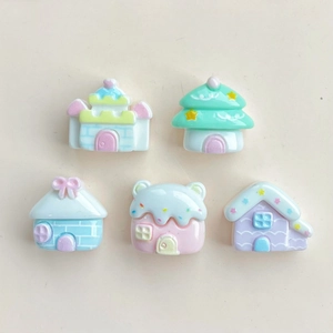 Flat lay of colorful miniature resin cartoon houses for DIY hair clips and crafts