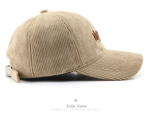 Detail of vintage beige corduroy baseball cap showing fine texture and brown embroidery