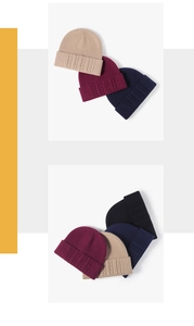 Detailed cable knit pattern on warm winter beanies in beige, red, navy, and black
