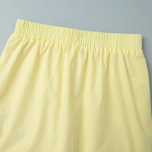Close-up of the wide elastic waistband on a summer yellow skirt with cotton texture