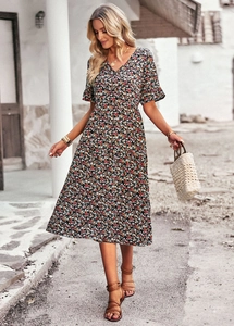 Close-up of a floral V-neck midi dress with small colorful flowers on a dark base