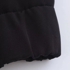 Detailed macro view of the fabric texture and stitching on black casual tracksuit set