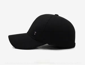 Detail of winter baseball cap featuring SPORT embroidery and tricolor side ribbon decoration