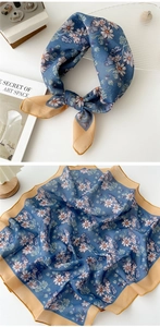 Detail of square floral silk scarf featuring daisy patterns and contrast beige borders