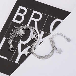 Close-up of double-layer silver bracelet with snake chain, star charms and butterfly pendant