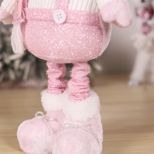 Detailed close-up of pink sequined fabric and plush fur boots on Christmas doll