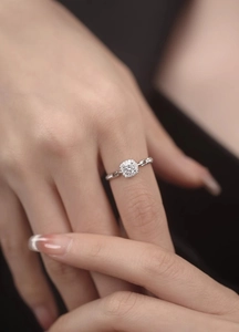 Close-up of sparkling square cut diamond ring with chain band design on a model's finger